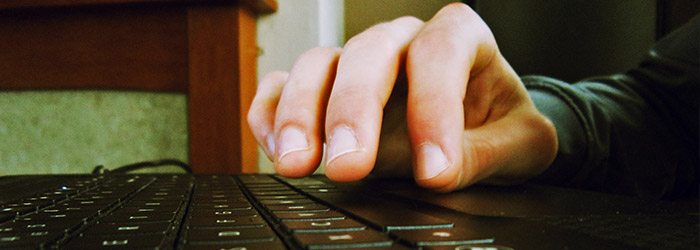 Hands typing on a keyboard